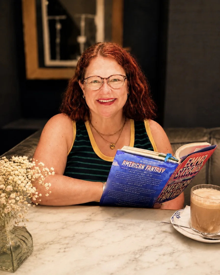Erin reading a book at a cafe