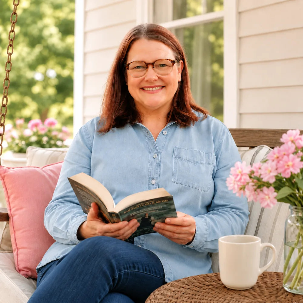 Erin sitting on a porch with a book